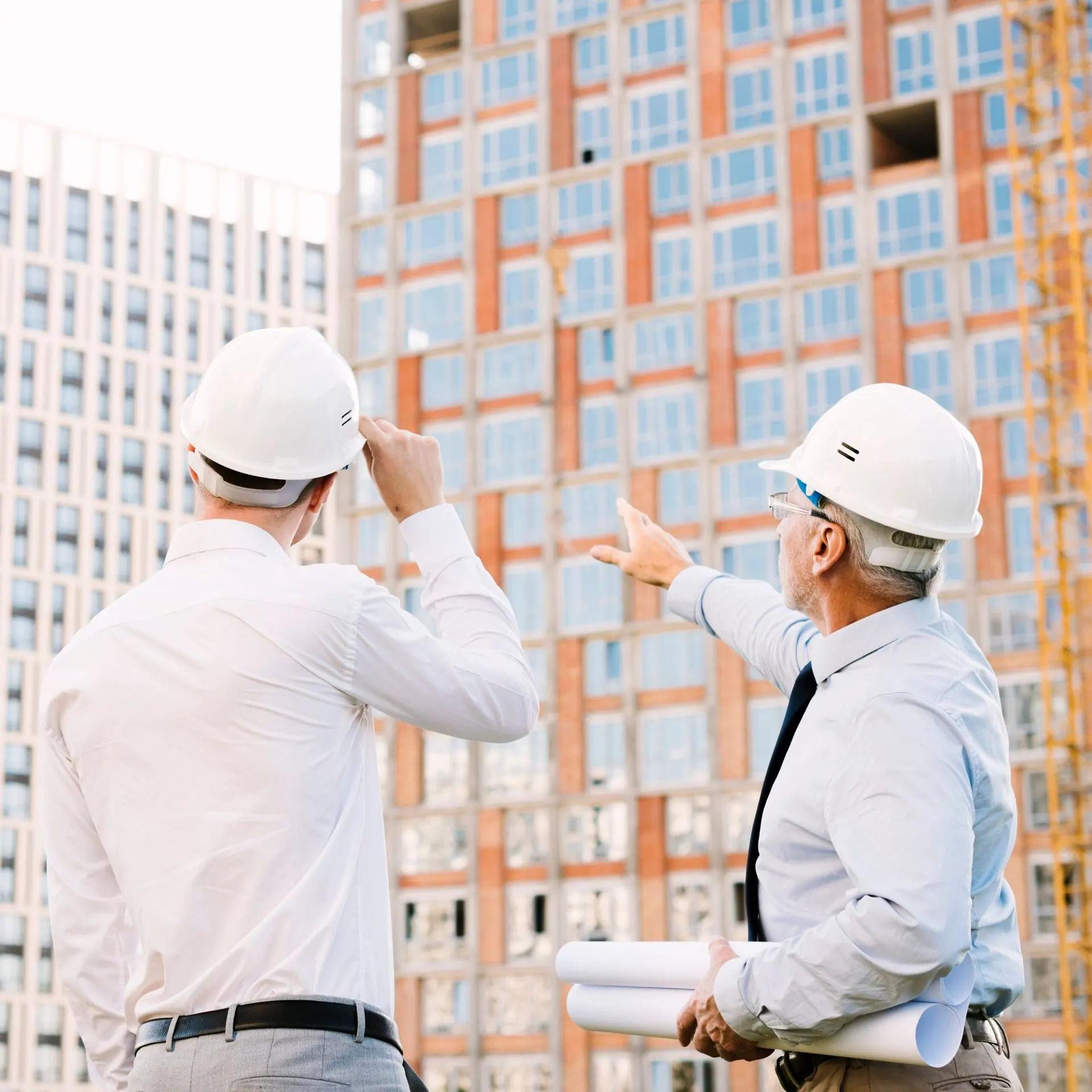 Inspector pointing out a building scaffolding issue during a condition assessment