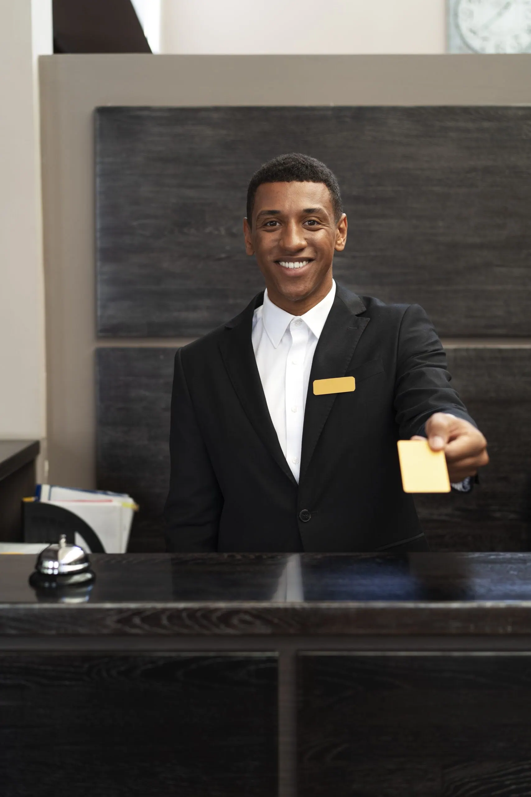 Front desk staff member handing over a key card