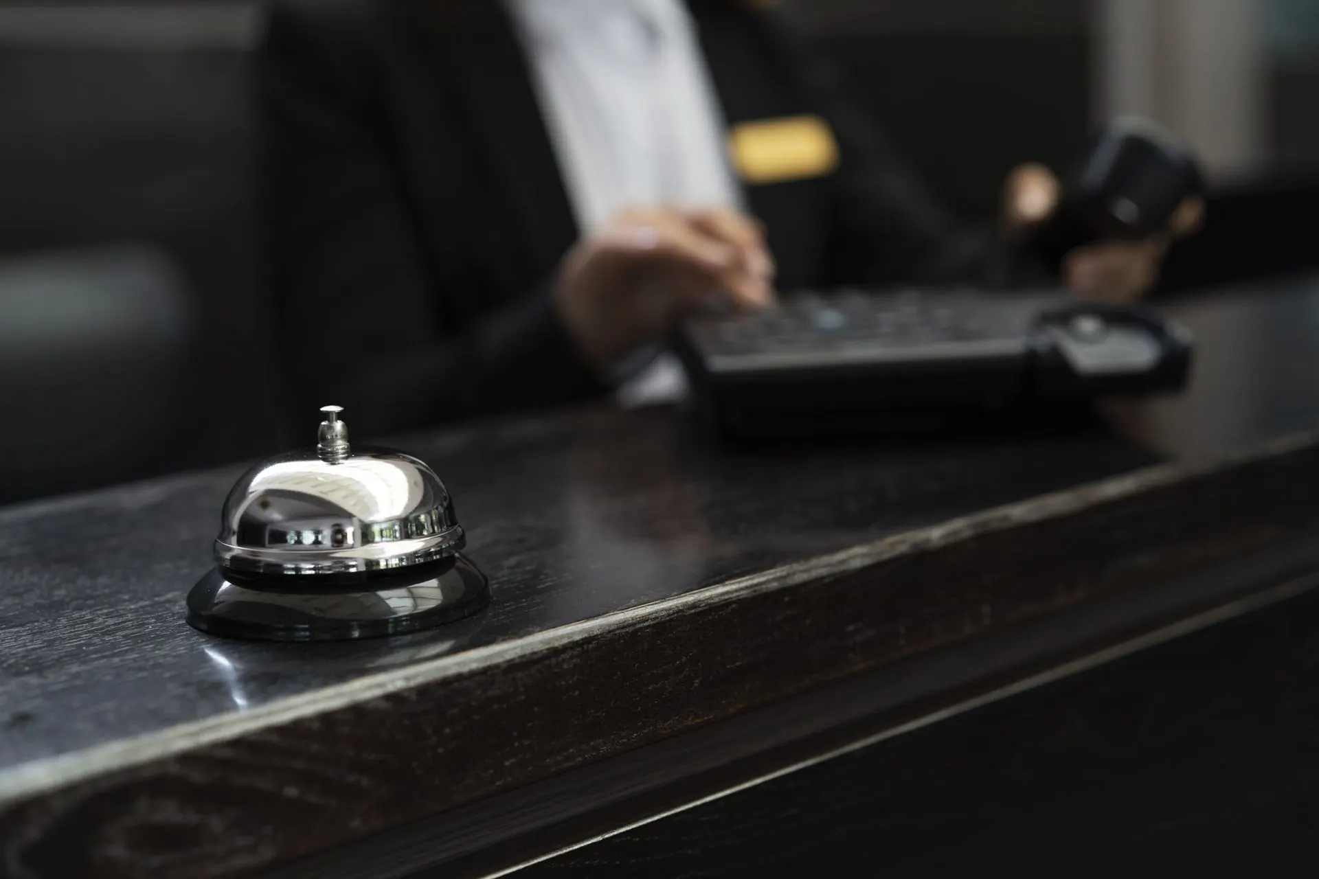 Close up of a service bell on a dark front desk