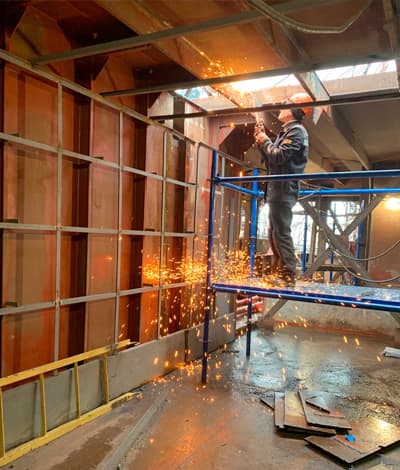 Building maintenance technician carrying out a compliance related inspection